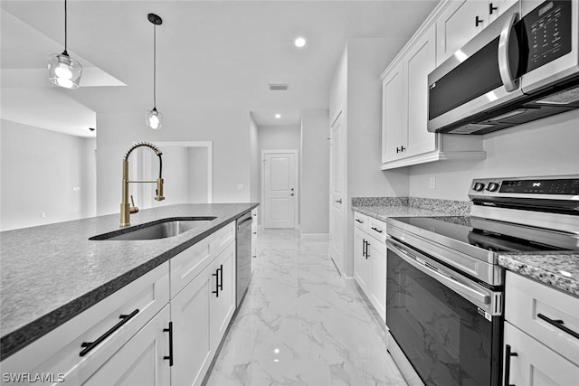 kitchen featuring visible vents, marble finish floor, a sink, decorative light fixtures, and appliances with stainless steel finishes