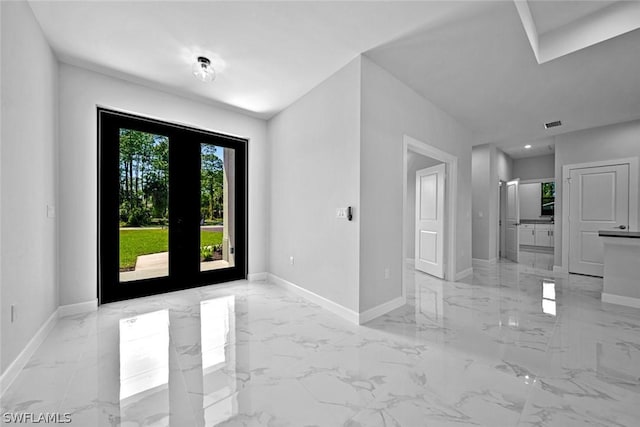 foyer entrance with marble finish floor and baseboards