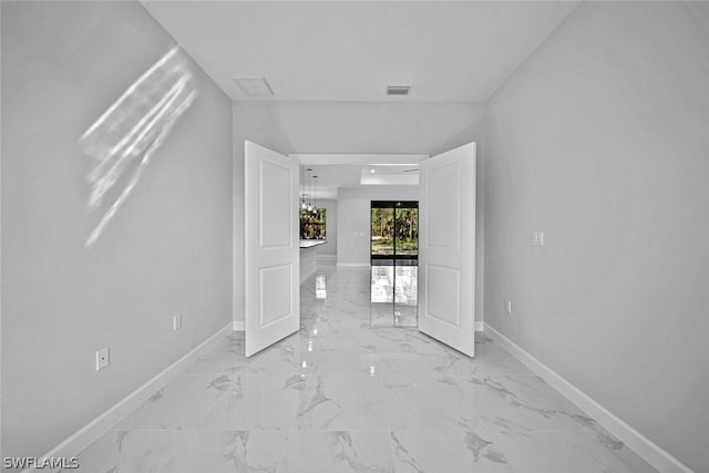 interior space with visible vents, baseboards, and marble finish floor