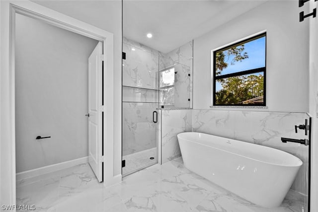 bathroom featuring recessed lighting, marble finish floor, a marble finish shower, and a freestanding bath