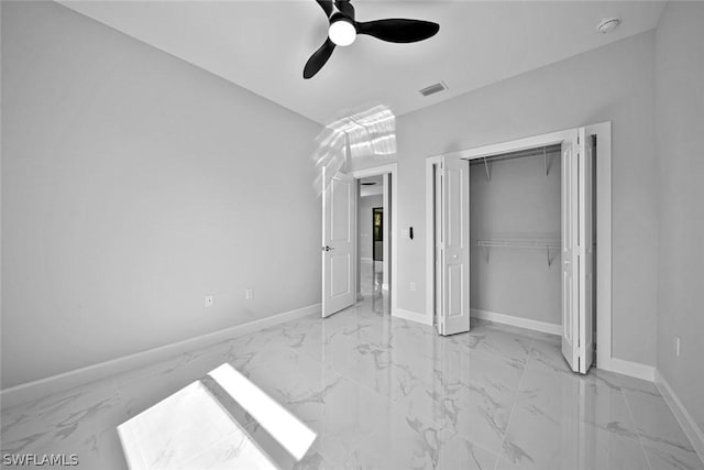 unfurnished bedroom featuring visible vents, baseboards, marble finish floor, and a closet