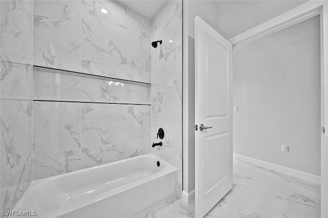 full bathroom featuring washtub / shower combination, baseboards, and marble finish floor