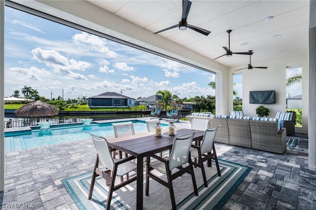 view of patio featuring ceiling fan, an outdoor hangout area, and a fenced in pool