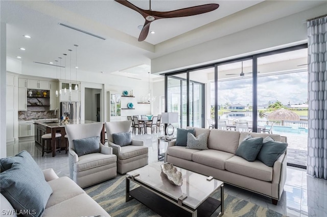 living room with ceiling fan and sink