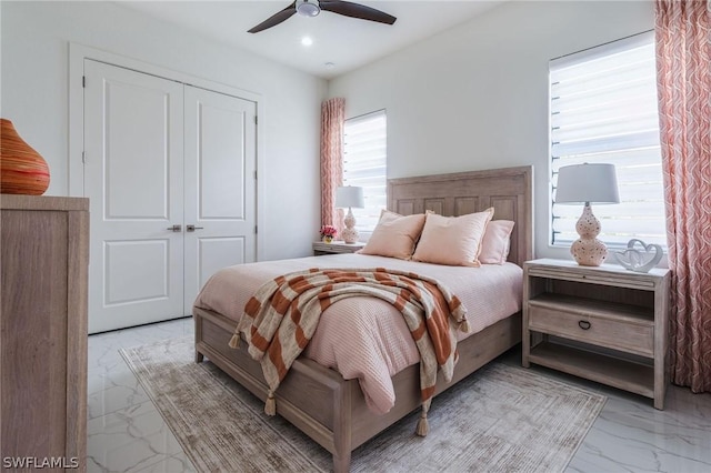 bedroom with ceiling fan and a closet