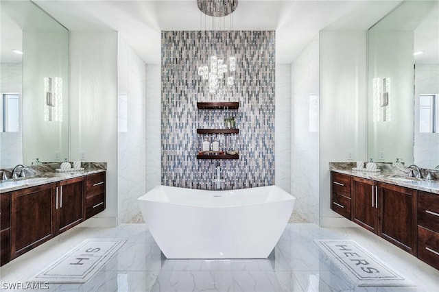 bathroom with vanity, tile walls, and a bathtub