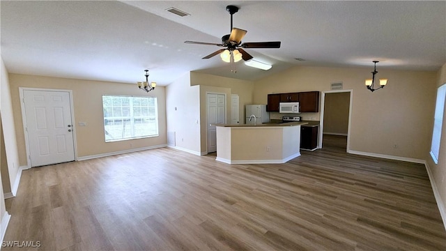 kitchen featuring white appliances, lofted ceiling, ceiling fan with notable chandelier, dark brown cabinets, and light hardwood / wood-style floors