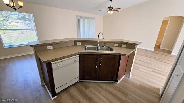 kitchen with dark brown cabinetry, white dishwasher, light hardwood / wood-style floors, and sink