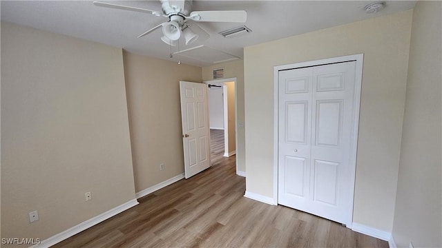 unfurnished bedroom featuring ceiling fan, a closet, and light hardwood / wood-style floors