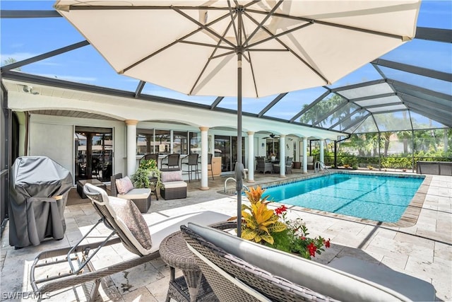 view of swimming pool featuring a lanai, outdoor lounge area, and a patio area