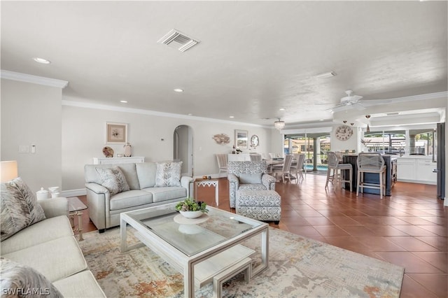 tiled living room featuring crown molding and ceiling fan