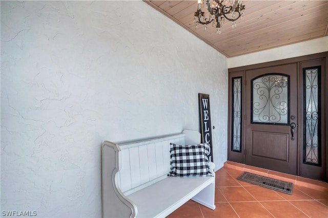 foyer entrance featuring wood ceiling, lofted ceiling, a chandelier, and tile patterned flooring