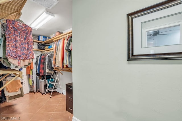 spacious closet featuring light tile patterned floors and ceiling fan