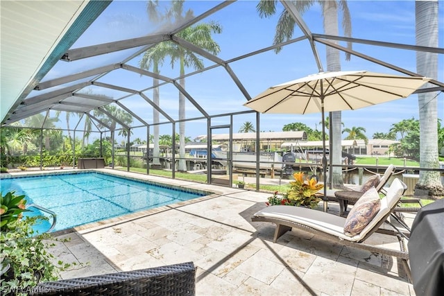 view of pool with a patio area and glass enclosure