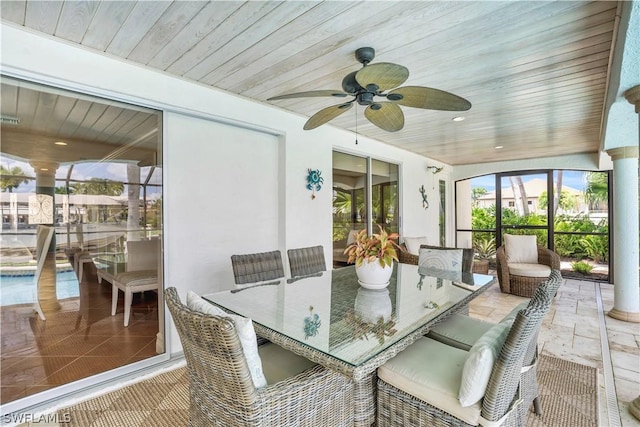 sunroom / solarium featuring wood ceiling and ceiling fan