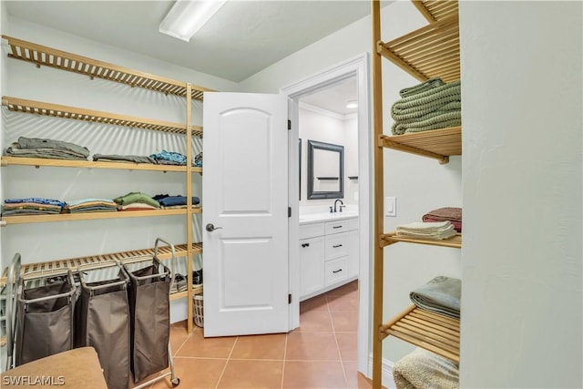 walk in closet with light tile patterned floors