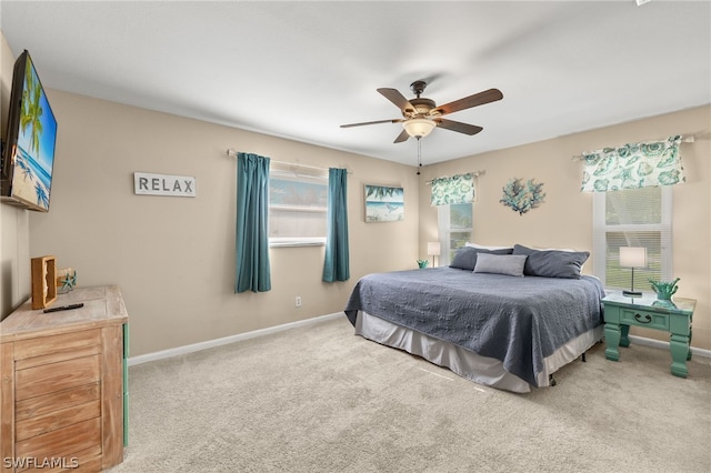 carpeted bedroom featuring a ceiling fan and baseboards