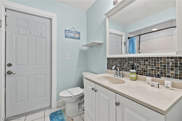 bathroom featuring toilet, tile patterned floors, tasteful backsplash, and vanity