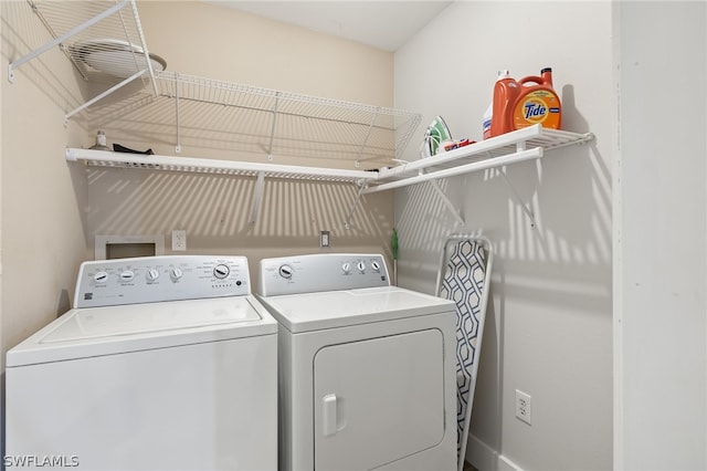 laundry room featuring washing machine and clothes dryer