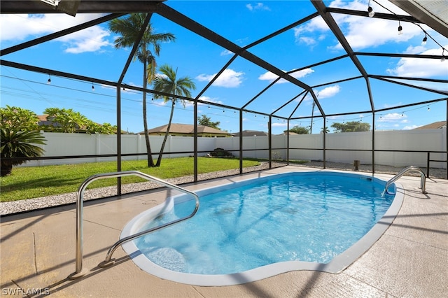 view of swimming pool featuring a yard and a lanai