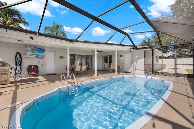 view of pool with ceiling fan, a patio area, and a lanai