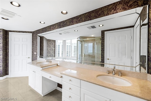 full bath with double vanity, visible vents, a shower stall, and a sink