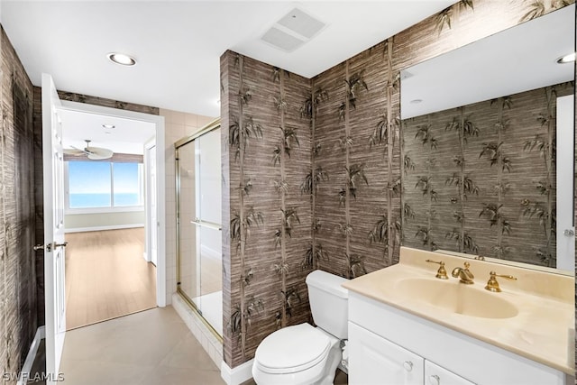 full bath with vanity, visible vents, a shower stall, tile walls, and toilet