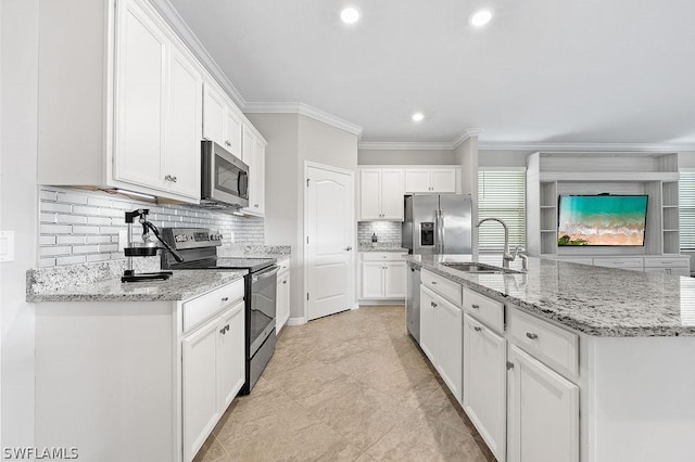 kitchen featuring sink, ornamental molding, light stone counters, white cabinetry, and stainless steel appliances