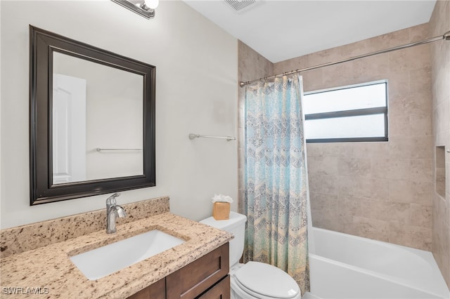 full bathroom with vanity, shower / bath combo, and toilet