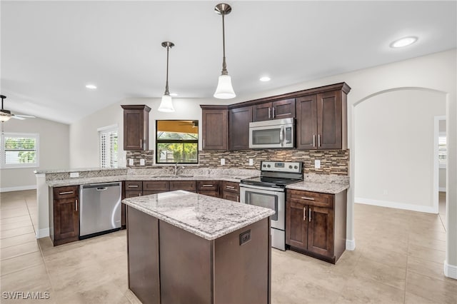 kitchen with decorative light fixtures, lofted ceiling, sink, ceiling fan, and stainless steel appliances