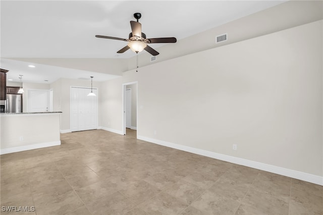 empty room with lofted ceiling and ceiling fan