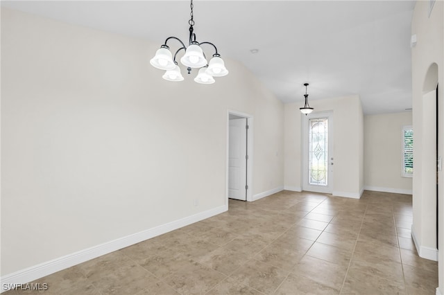 interior space with lofted ceiling and a chandelier