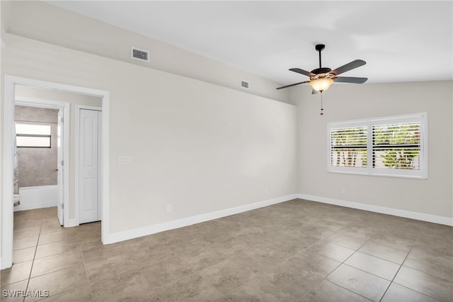 unfurnished room with light tile patterned floors and ceiling fan