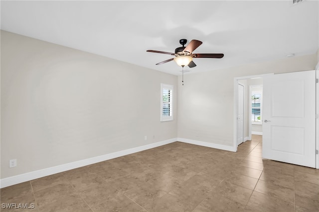 empty room with a healthy amount of sunlight and ceiling fan