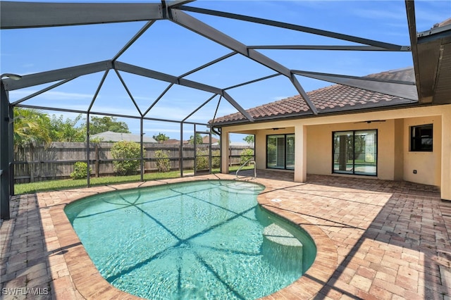 view of swimming pool featuring a patio, ceiling fan, and glass enclosure