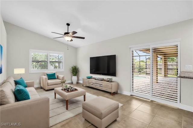 living room featuring vaulted ceiling, a healthy amount of sunlight, light tile patterned floors, and ceiling fan