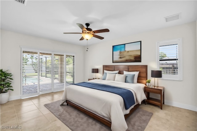 tiled bedroom with multiple windows, access to exterior, and ceiling fan