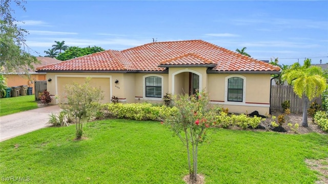 mediterranean / spanish-style house featuring a front yard and a garage