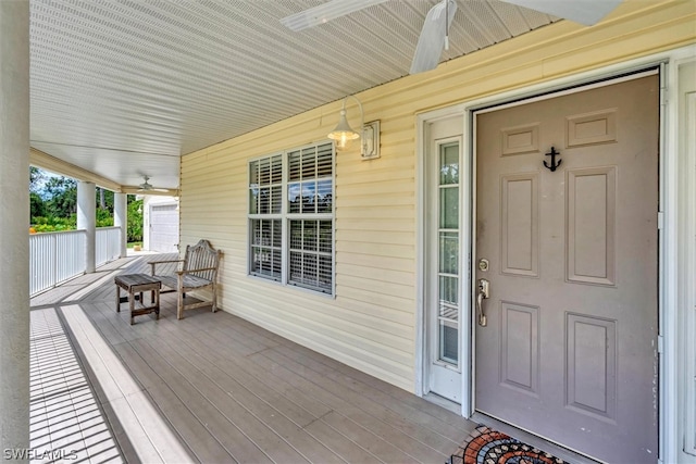 doorway to property with a porch and ceiling fan