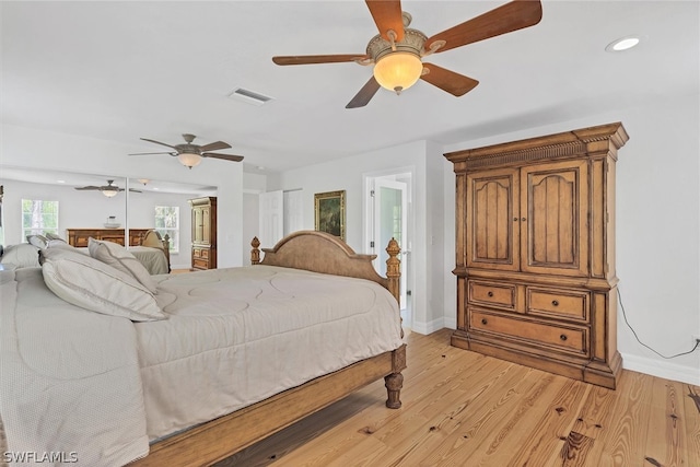 bedroom with light hardwood / wood-style floors and ceiling fan