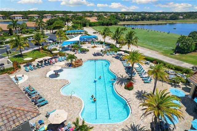 view of swimming pool with a water view and a patio