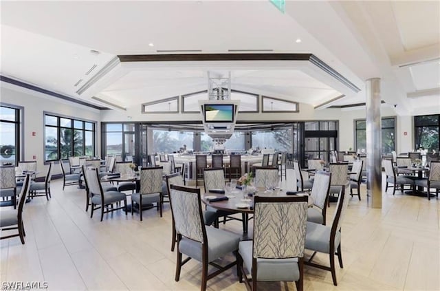 dining space featuring lofted ceiling with beams