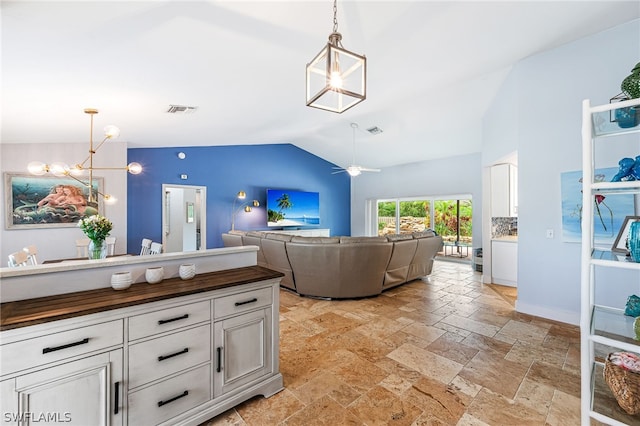 living room with ceiling fan and lofted ceiling