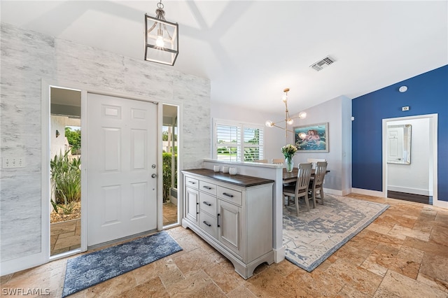 foyer entrance with a chandelier