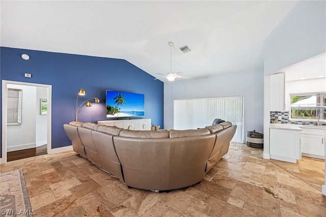 living room with vaulted ceiling, sink, and ceiling fan