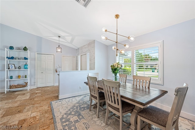 dining space with lofted ceiling and an inviting chandelier