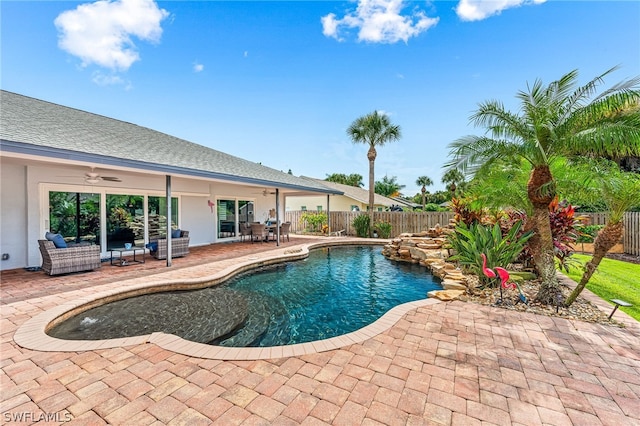 view of pool featuring an outdoor living space, a patio, and ceiling fan