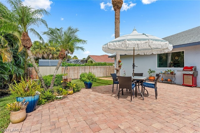 view of patio with a gazebo, area for grilling, and a shed