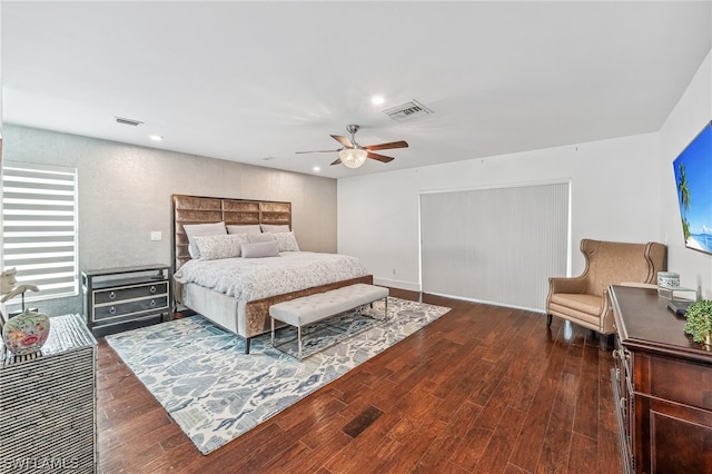 bedroom with dark hardwood / wood-style floors and ceiling fan