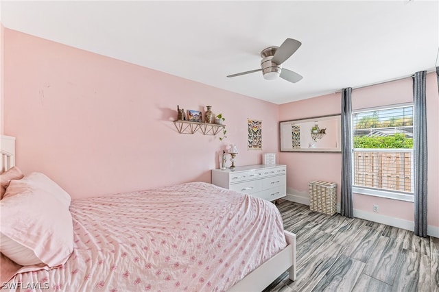 bedroom with ceiling fan and light hardwood / wood-style floors